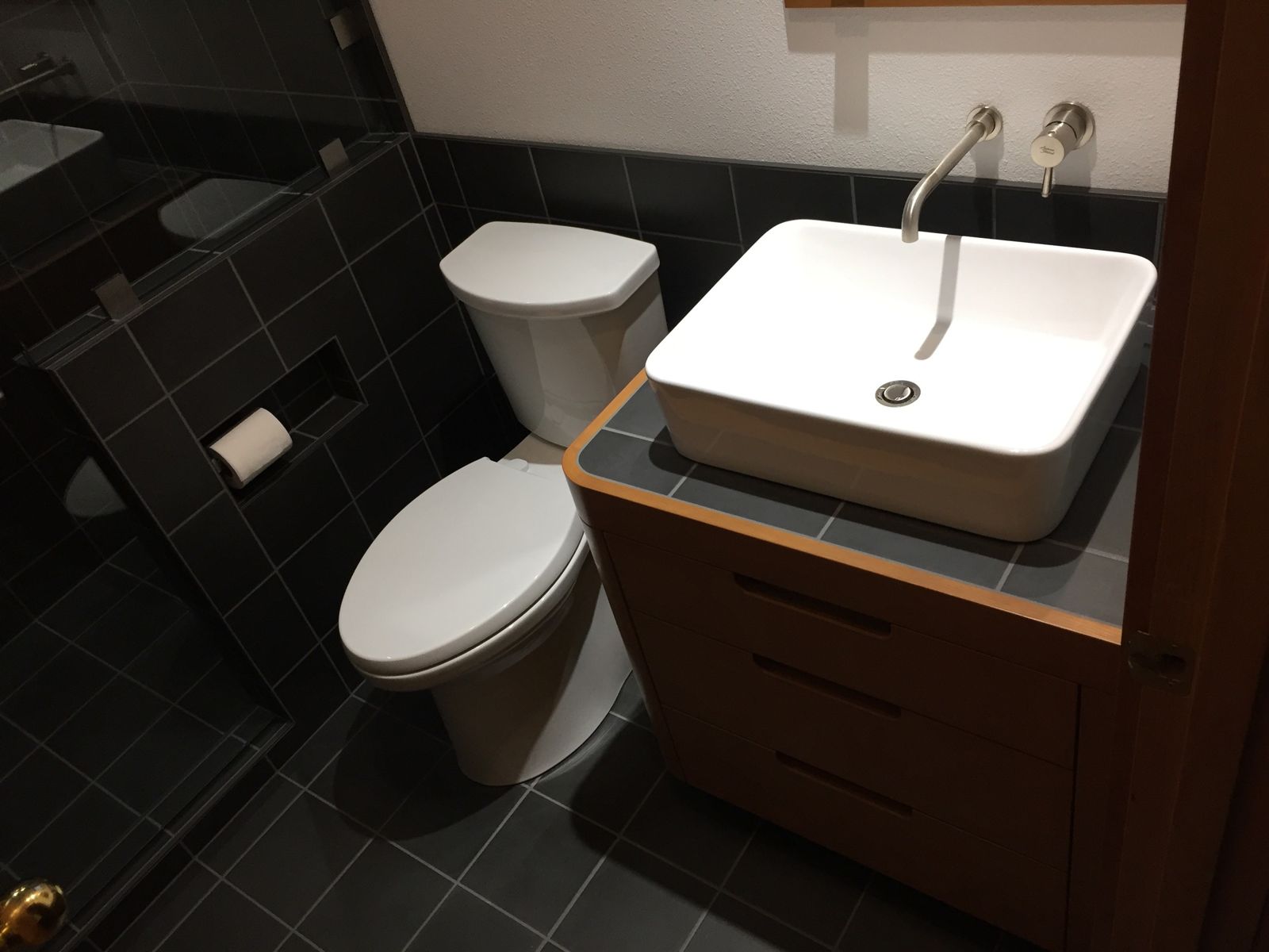 Luxury bathroom with dark slate tile and vessel sink