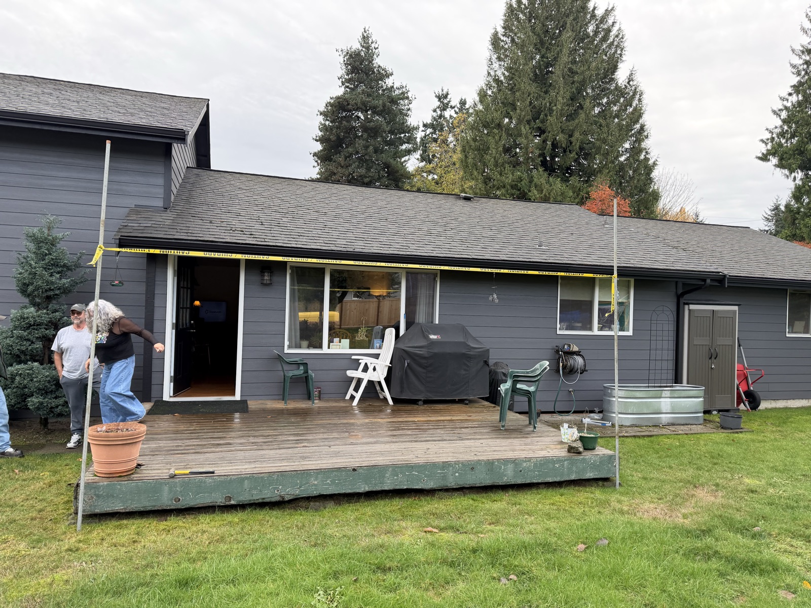 Original well-used wood deck before a covered patio transformation
