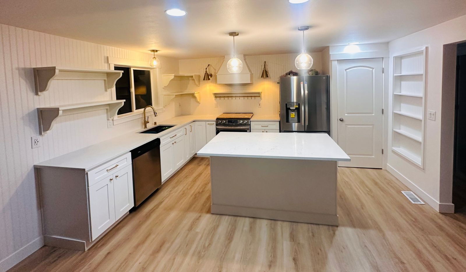 Farmhouse-style kitchen remodel with center island, pendant lighting, and open shelving