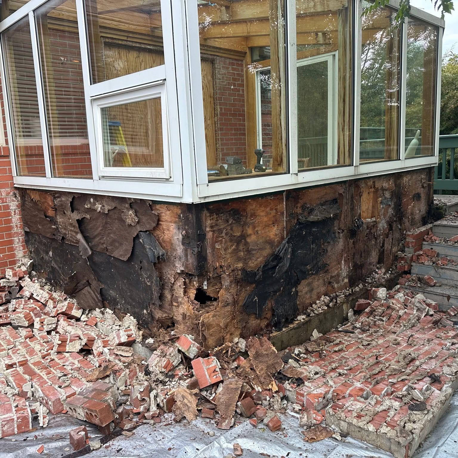 Dry-rot remediation at a brick and wood corner