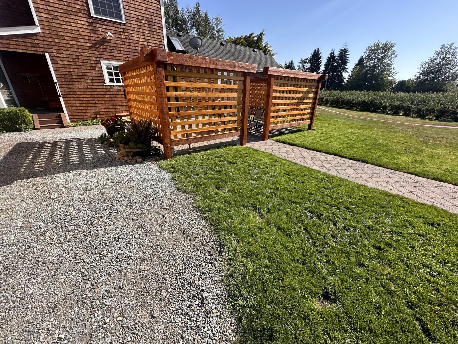 Cedar lattice privacy screens and paver walkway