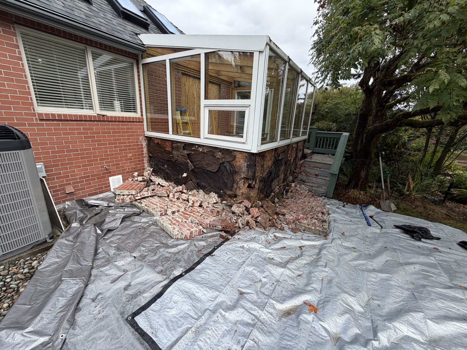 Demo stage with rotted brick and framing removed from the former sunroom