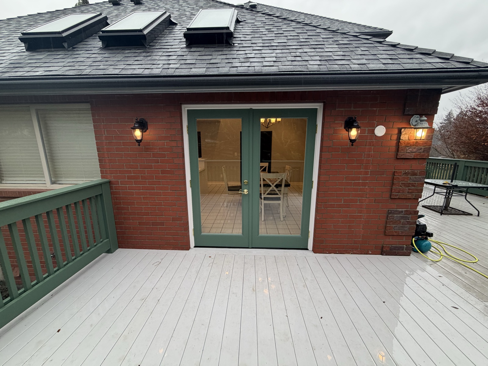 Finished green French doors after the sunroom-to-deck conversion